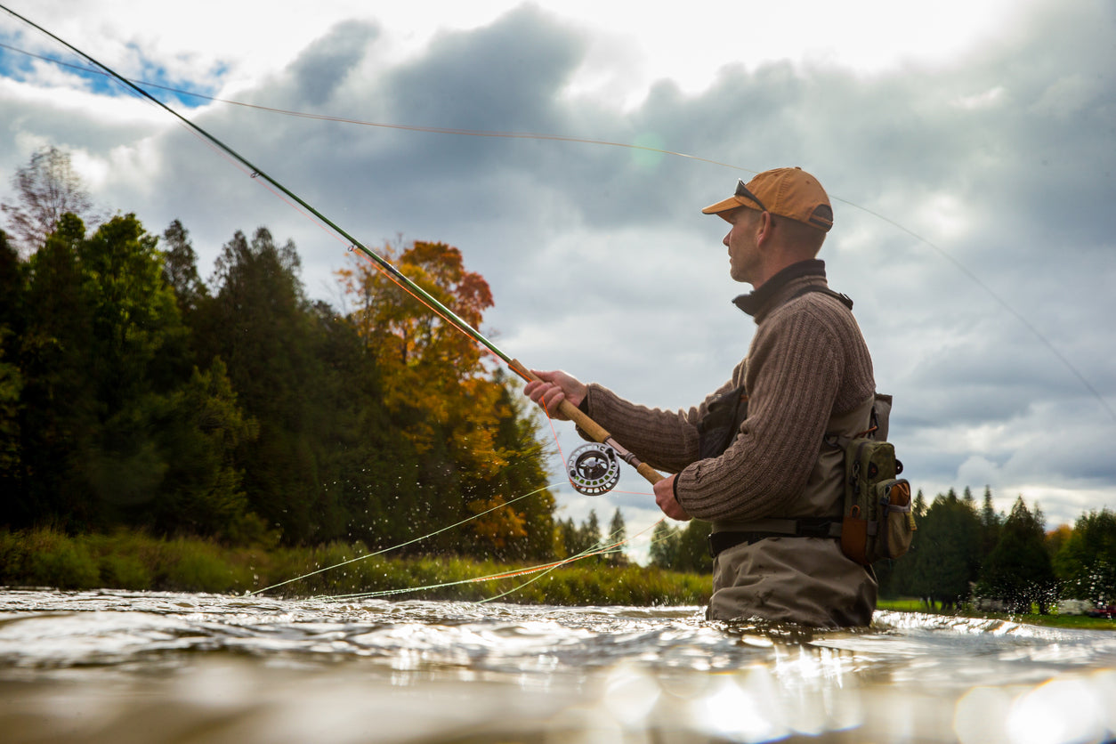 man fly fishing in autumn