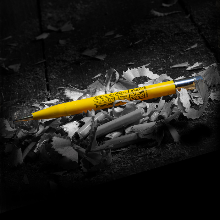 a yellow pen on a bed of sharpenings