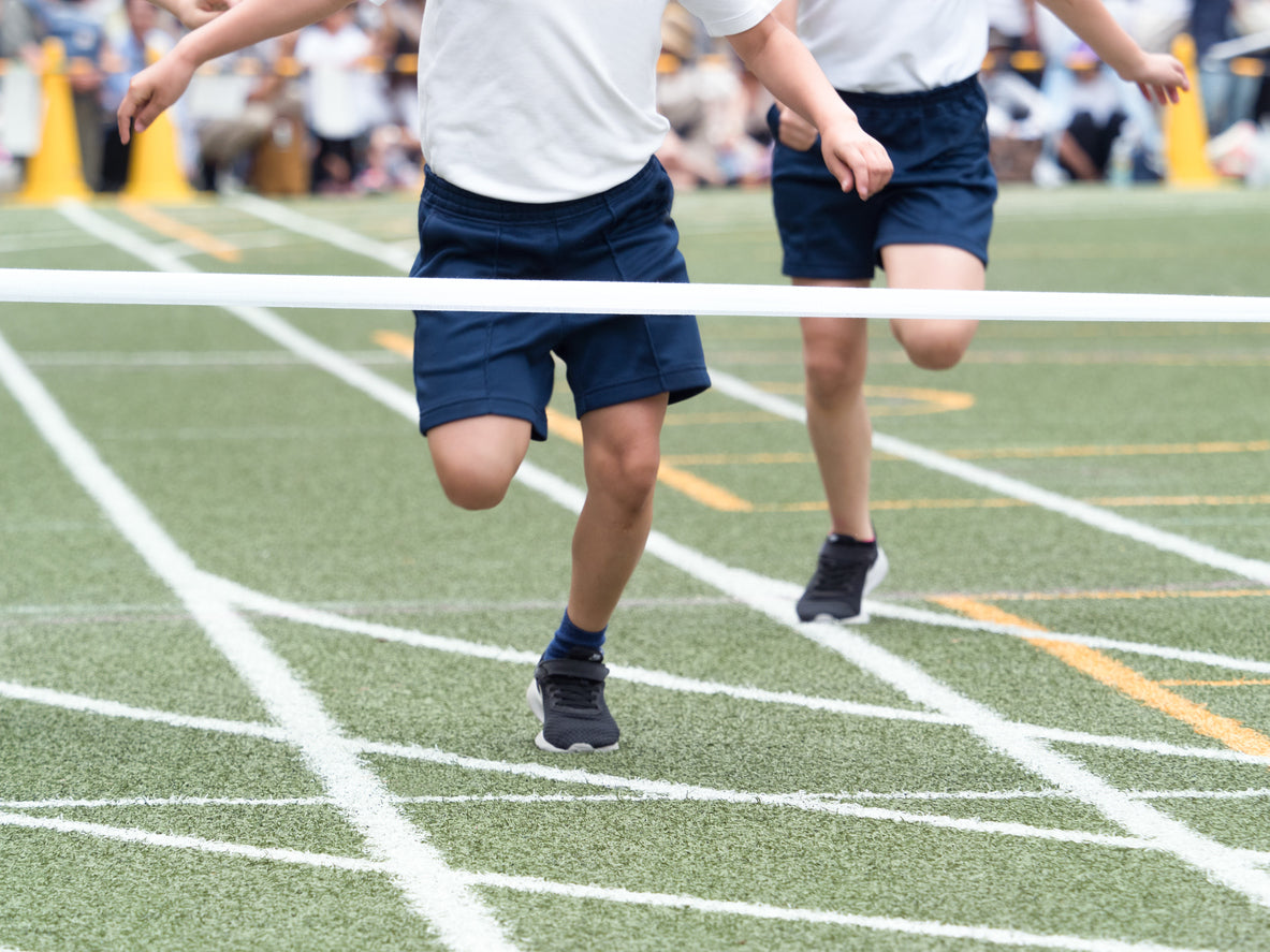 child running on track at sports day