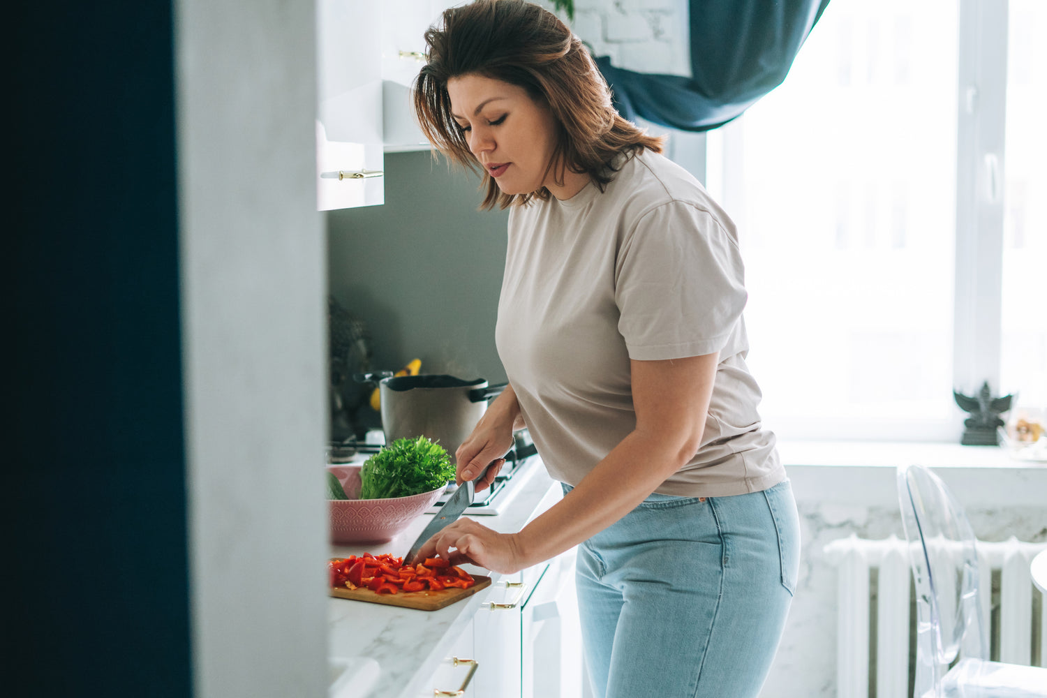 woman chopping red peppers